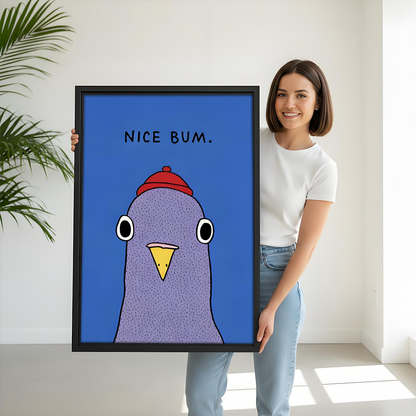 Woman holding large framed funny pigeon Nice Bum wall art print showing size scale on cobalt blue background