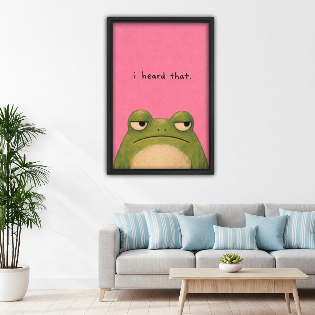 Framed funny pink frog canvas wall art above a gray sofa with light blue cushions