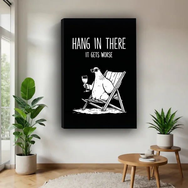 Woman holding black-framed funny polar bear canvas wall art with a sunglasses-wearing bear and Hang in There lettering.