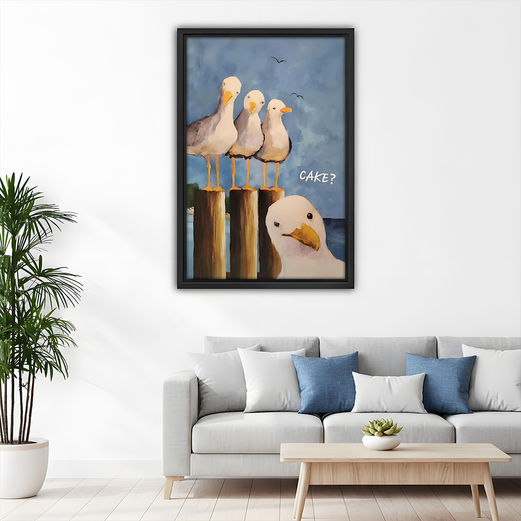 Framed funny seagull CAKE coastal canvas art above a light gray sofa with blue pillows in a modern living room