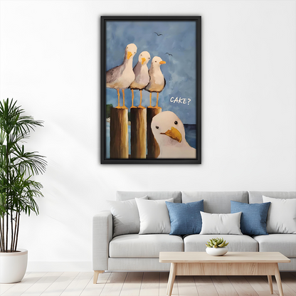 Framed funny seagull CAKE coastal canvas art above a light gray sofa with blue pillows in a modern living room