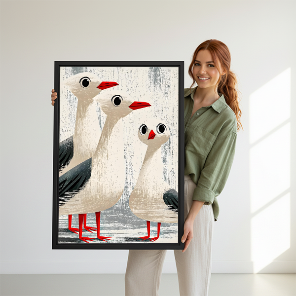 Smiling woman holding funny seagull trio vintage framed art print showing size reference on white studio background