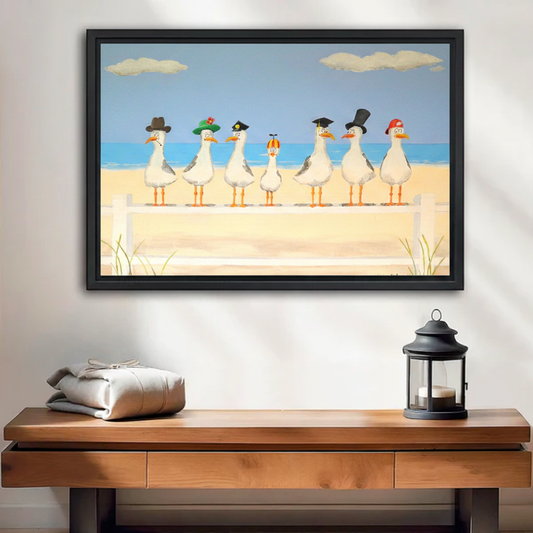  Seven funny cartoon seagulls wearing different hats on beach fence, black framed wall art above wooden console table