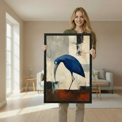 Woman holding large geometric blue heron abstract framed canvas wall art print in bright airy living room