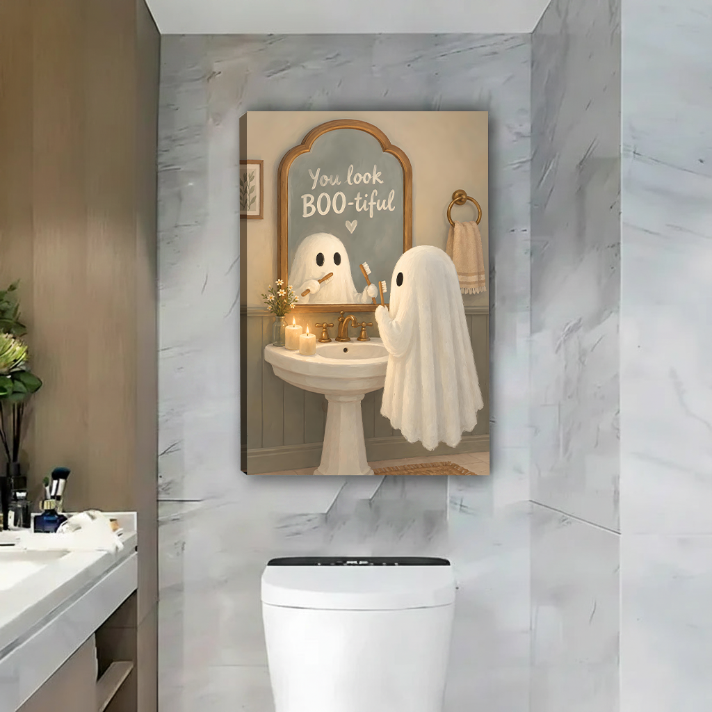 Two friends hanging framed cute ghost bathroom canvas wall art with a BOO-tiful mirror message above a toilet