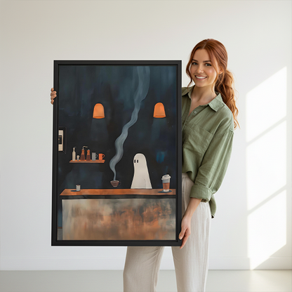 Black-framed ghost coffee shop canvas wall art on a wall above small tables and plants.