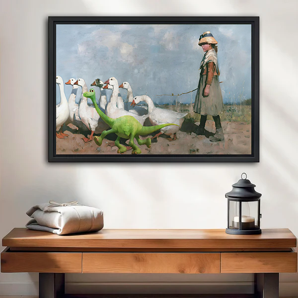 Black-framed girl, geese, and dinosaur canvas wall art above a wooden console with folded blankets and a lantern.