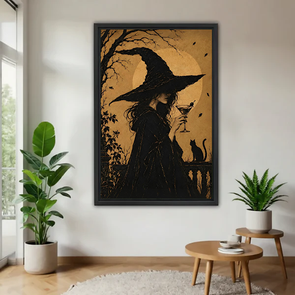 Framed golden moon witch silhouette and black cat canvas wall art beside plants and a round wood table