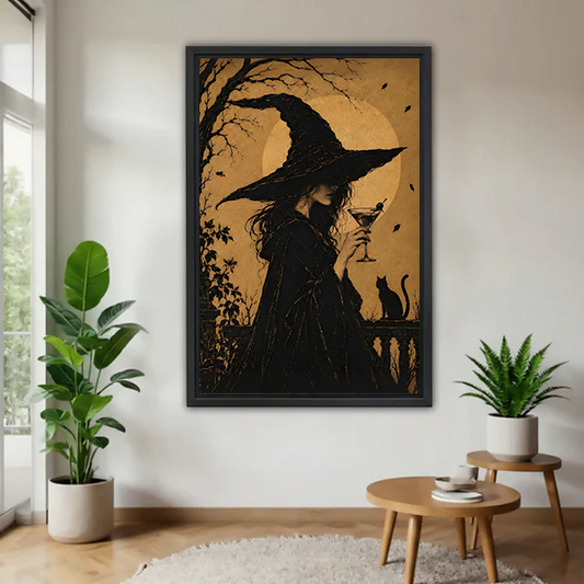 Framed golden moon witch silhouette and black cat canvas wall art beside plants and a round wood table