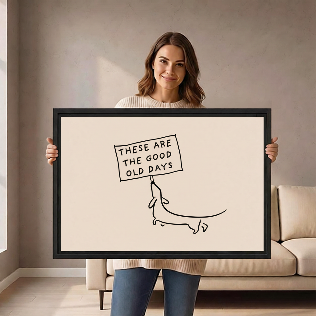 Woman holding large good old days dachshund line art framed canvas to show size scale in living room