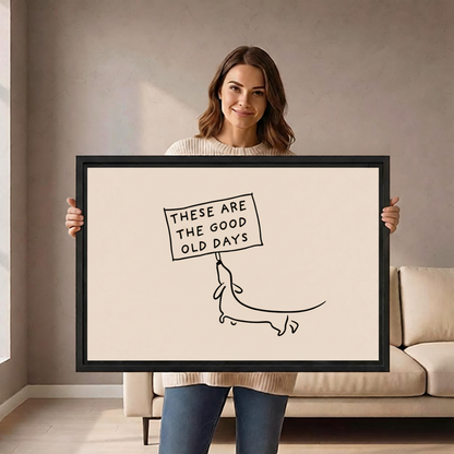 Woman holding large good old days dachshund line art framed canvas to show size scale in living room