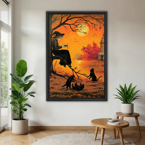 Woman holding gothic Halloween witch canvas wall art, showing a reading witch, black cats, and orange autumn sky