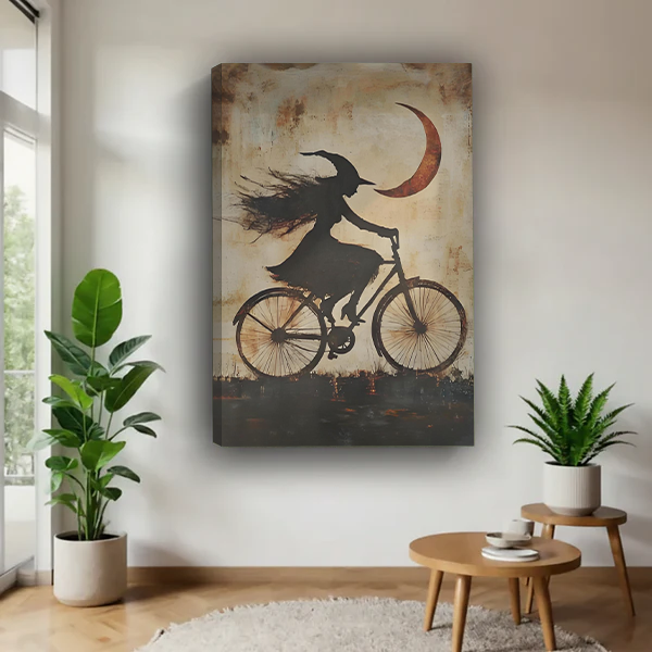 Gothic witch bicycle canvas wall art displayed above a warm neutral bed in a moody bedroom