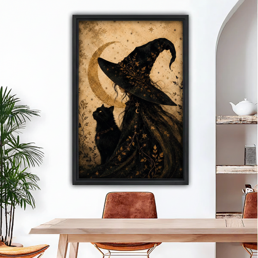 Framed gothic witch black cat crescent moon canvas print hung above wooden dining table