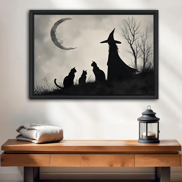 Gothic silhouette witch and two black cats gazing at crescent moon framed canvas wall art above entryway console table
