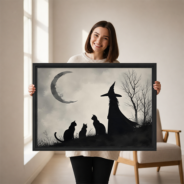 Woman holding gothic witch and black cats crescent moon canvas wall art showing framed print size
