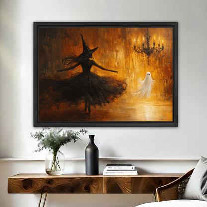 Gothic oil painting of black-clad dancing witch facing luminous white ghost under candle chandelier in amber tones framed canvas above walnut console table