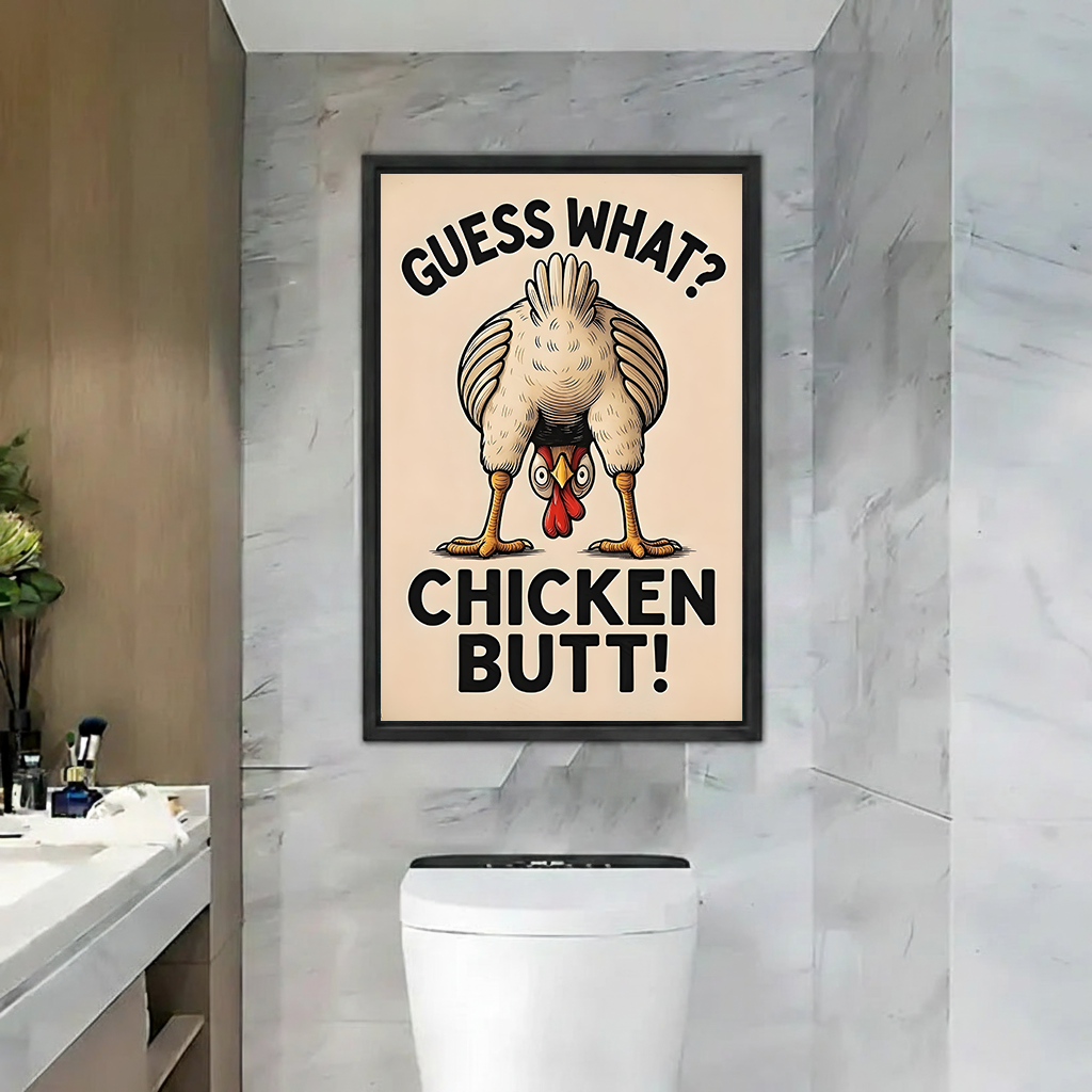 Black-framed Guess What Chicken Butt canvas wall art with retro lettering displayed above a toilet in a marble bathroom.