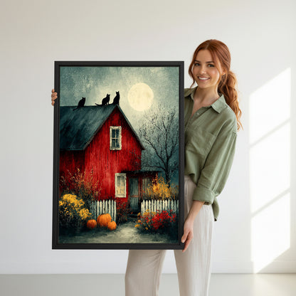 Smiling redhead woman in sage green shirt holding large Halloween red barn three black cats full moon oil painting pumpkins autumn wildflowers black framed canvas wall art size reference in bright white room with natural side light