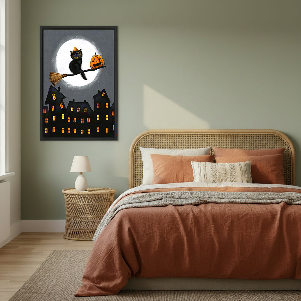 Halloween black cat orange witch hat broomstick jack-o-lantern full moon gothic town black framed canvas wall art on sage green wall beside rattan headboard bed with terracotta linen and wicker nightstand