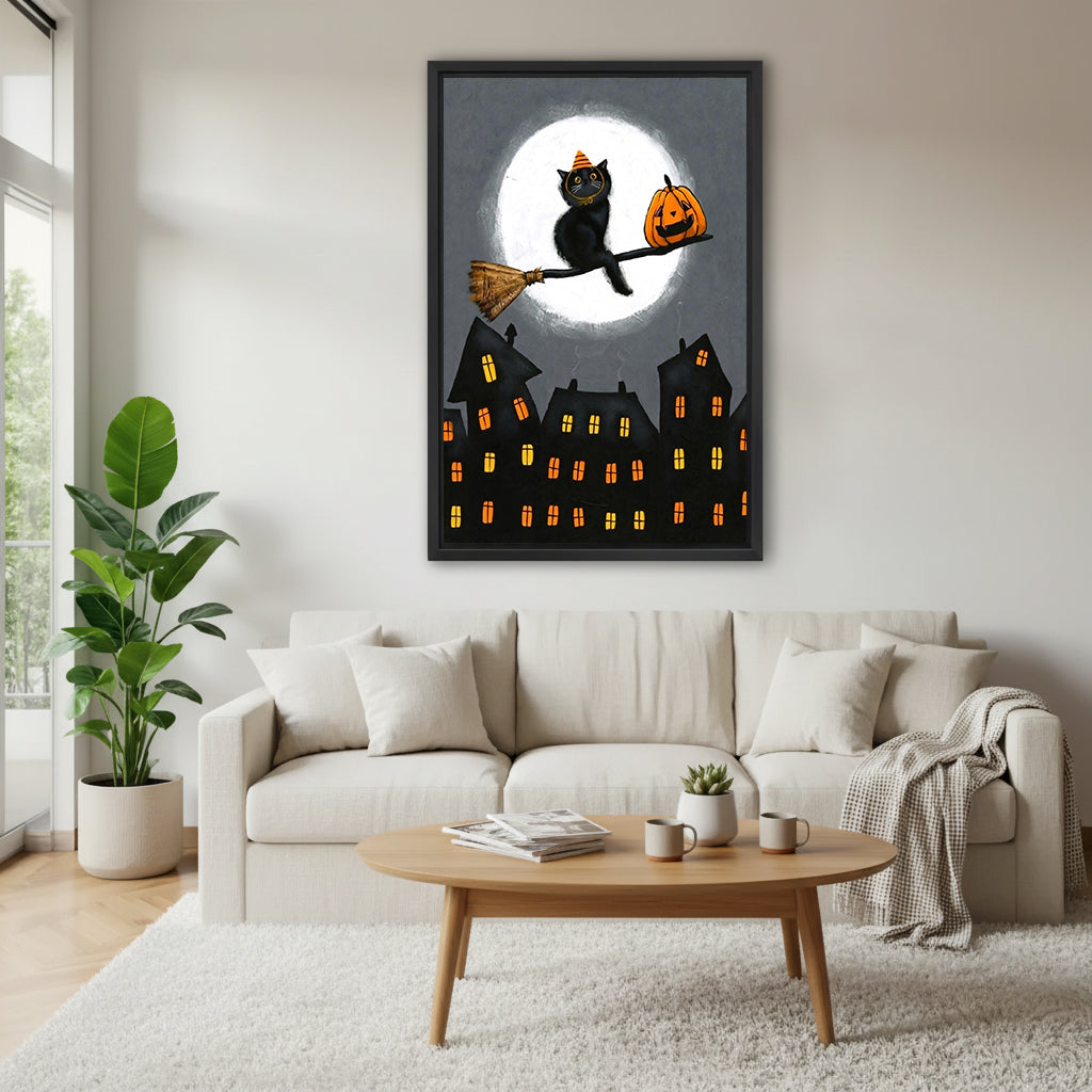 Halloween black cat witch hat broomstick pumpkin full moon haunted town black framed canvas wall art above wide cream linen sofa with plaid throw wood oval coffee table and succulent
