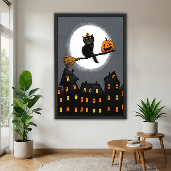 Halloween black cat orange striped witch hat broomstick jack-o-lantern full moon haunted gothic town black framed canvas wall art on gray wall above wood round side table with green tropical plants