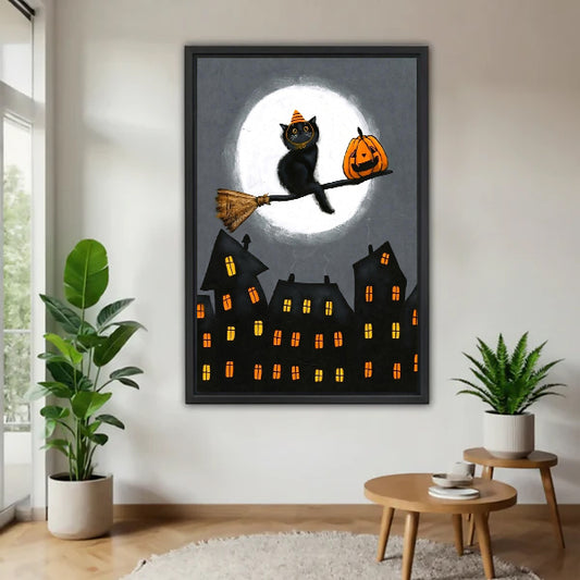 Halloween black cat orange striped witch hat broomstick jack-o-lantern full moon haunted gothic town black framed canvas wall art on gray wall above wood round side table with green tropical plants