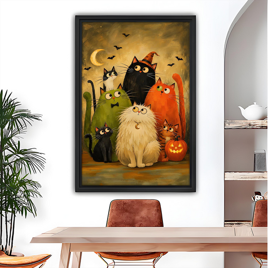 Whimsical Halloween cats canvas wall art in a black frame above a white sofa with blue cushions.