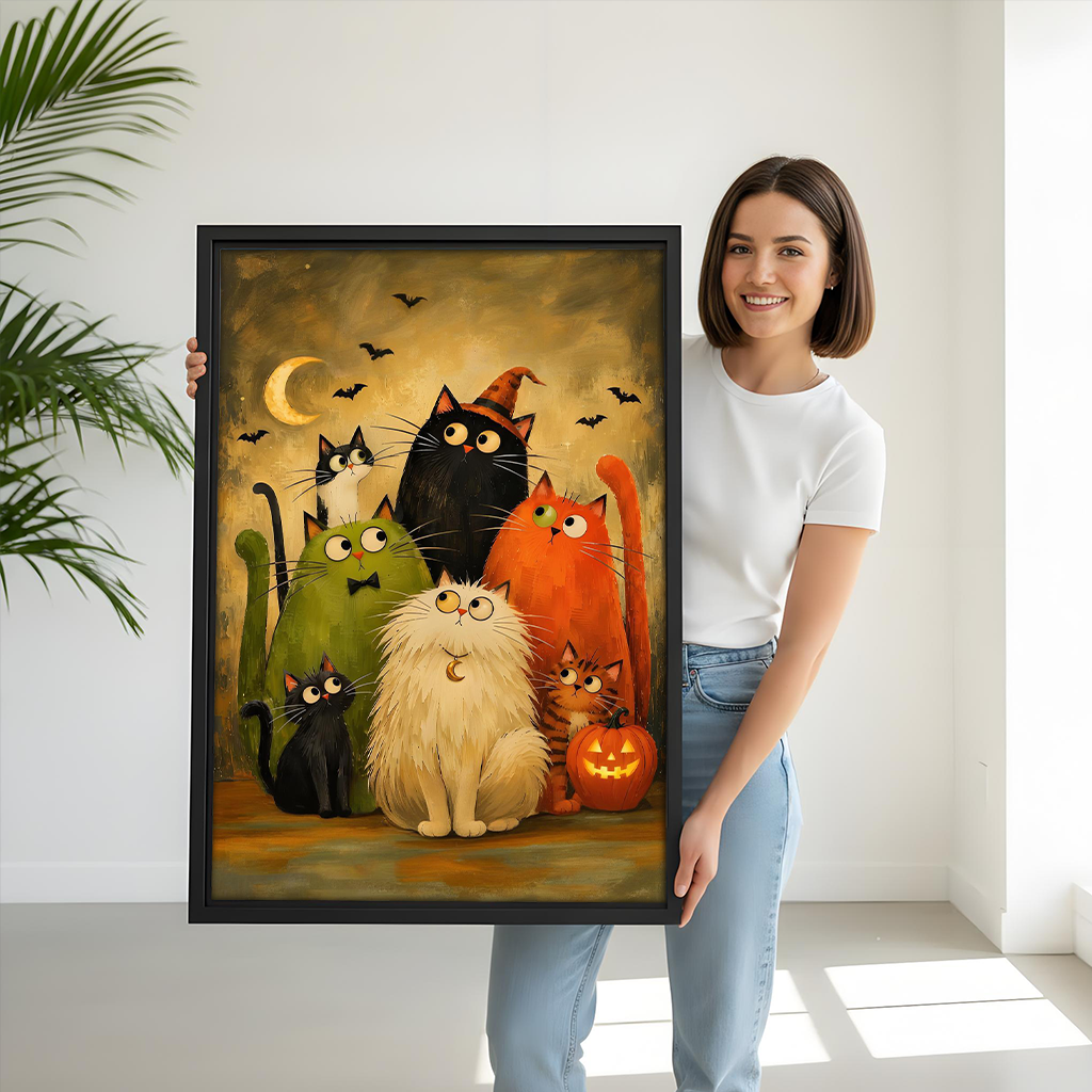 Woman holding black-framed Halloween cats canvas wall art with seven whimsical cats, bats, and a pumpkin.