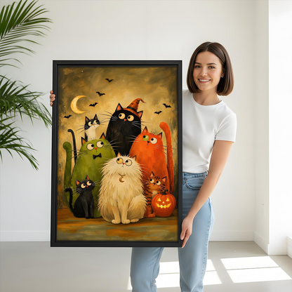 Woman holding black-framed Halloween cats canvas wall art with seven whimsical cats, bats, and a pumpkin.