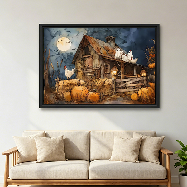 Woman holds framed Halloween farmhouse canvas wall art featuring a rustic barn, white ghosts, and pumpkins.