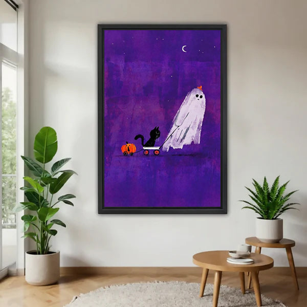 Halloween ghost pumpkin hat black cat orange pumpkin cart purple crescent moon star sky black framed canvas wall art on white wall beside wood round side table and tropical green plants