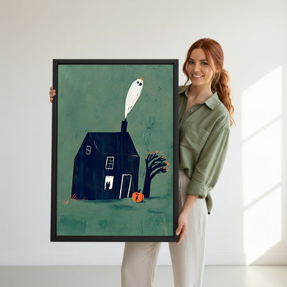 Smiling redhead woman holding large Halloween ghost haunted dark house pumpkin teal black framed canvas wall art size reference in bright white room with natural window light