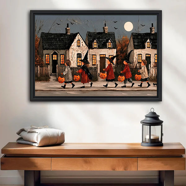 Vintage Halloween parade canvas wall art in a black frame above a wooden bench with a candle lantern