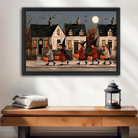 Vintage Halloween parade canvas wall art in a black frame above a wooden bench with a candle lantern