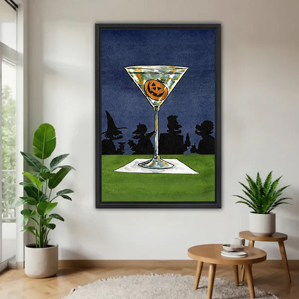 Halloween pumpkin jack-o-lantern martini cocktail retro art witch silhouette night sky black framed canvas wall art on white wall beside round wood side table with monstera and snake plant