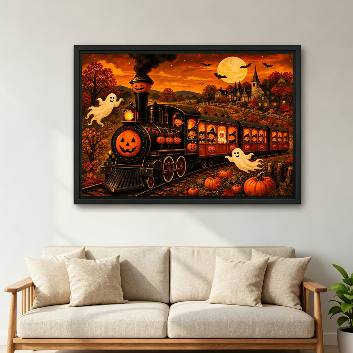 Large framed Halloween pumpkin train canvas wall art in vivid orange tones above a cream living room sofa