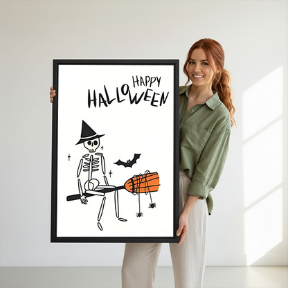 Woman holding framed Halloween skeleton canvas wall art featuring a witch hat, flying bat, and dangling spiders.