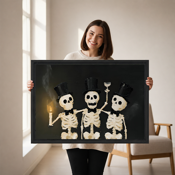 Black-framed Halloween skeleton trio canvas wall art with ivory bones and top hats displayed above a bed.