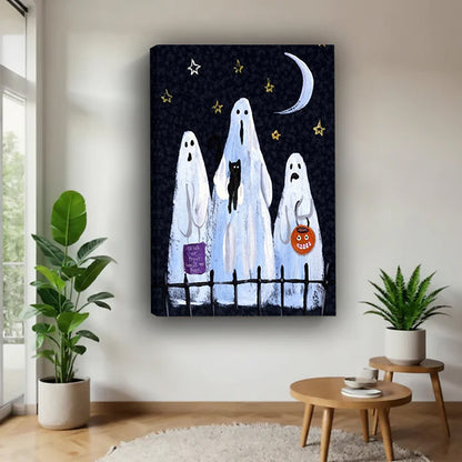 Halloween three white sheet ghosts trick or treat black cat pumpkin lantern crescent moon gold star sky gallery wrap canvas wall art on white wall beside round wood table with tropical and succulent plants