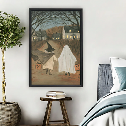 Woman holding framed Halloween trick-or-treat canvas wall art showing two children walking beneath bare trees