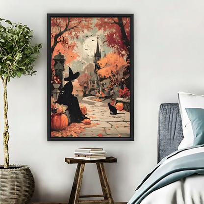 Black-framed Halloween witch and black cat canvas wall art with pumpkins and autumn trees displayed beside a bed.
