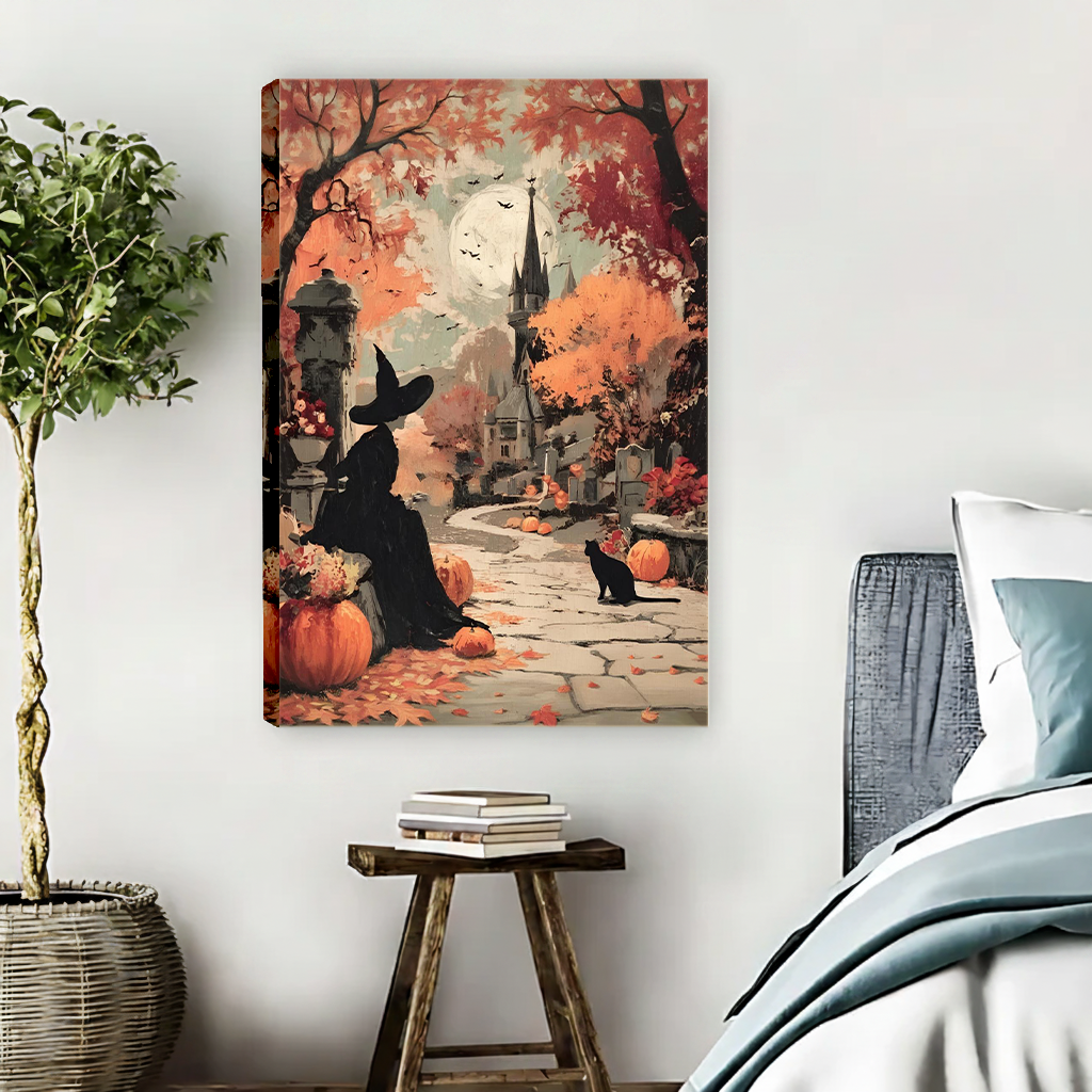 Framed Halloween witch and black cat canvas wall art with warm autumn foliage displayed above a cream sofa.