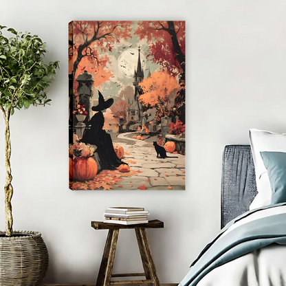 Framed Halloween witch and black cat canvas wall art with warm autumn foliage displayed above a cream sofa.