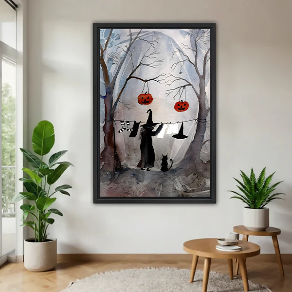 Halloween witch and cat canvas wall art with hanging pumpkins, displayed unframed in a bright living room.