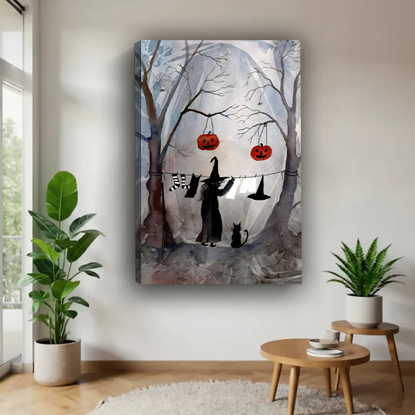 Framed Halloween witch and cat canvas wall art showing a moonlit forest above a cream sofa.