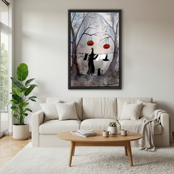 Woman holding framed Halloween witch and cat canvas wall art featuring bare trees and a misty moon.