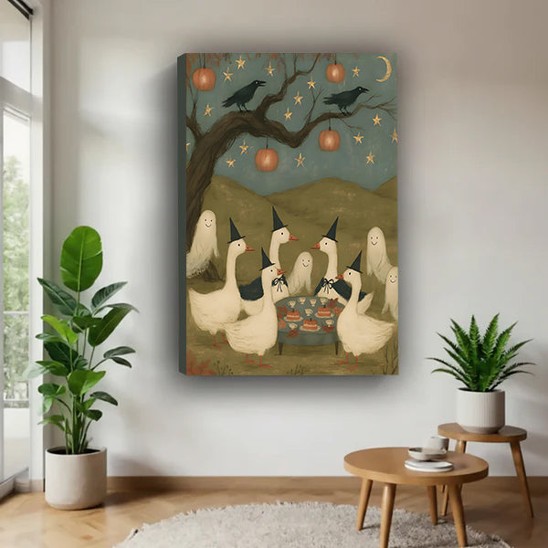 Halloween witch geese party folk art six white geese witch hats crow pumpkin lantern star moon sky gallery wrap canvas wall art on white wall beside round wood side table with monstera and aloe plants