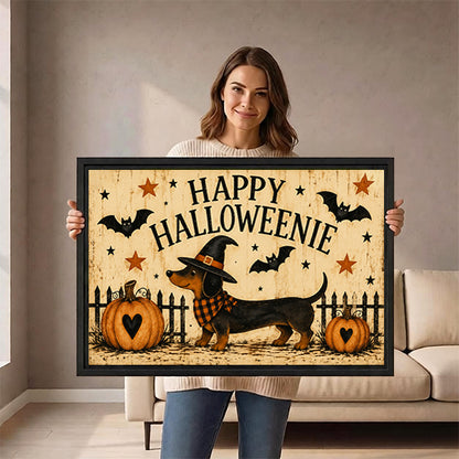 Smiling woman holding large Happy Halloweenie dachshund witch hat plaid scarf pumpkins bats stars folk retro horizontal black framed canvas wall art size reference in bright white room with natural side light