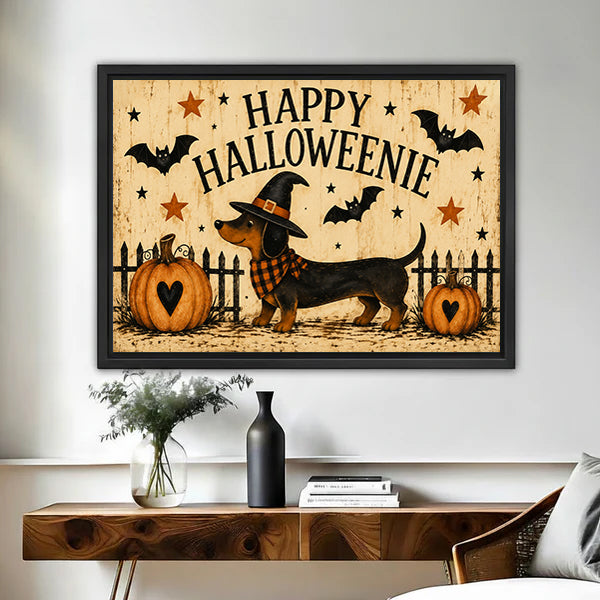 Happy Halloweenie dachshund witch hat plaid scarf pumpkins bats stars folk retro horizontal black framed canvas wall art on white wall above rustic wood console table with dark ceramic vase and white florals